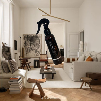 Living room with a bottle of 'The Lounge' spray in the foreground