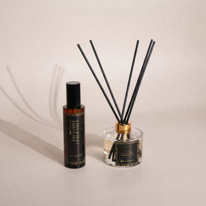 Diffuser bottle with reeds on a light gray background